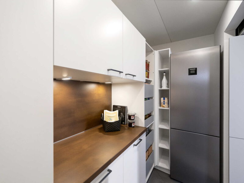 Rechte Seitenanansicht der Speisekammer mit Arbeitsfläsche und Kühlschrank